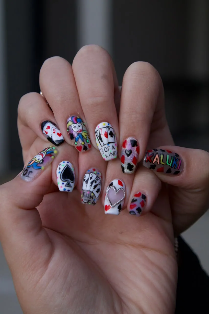 Hand-painted playing-card nail art across a full set